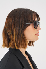 Profile view of model wearing the Oroton Folk Sunglasses in Black and Acetate for Women