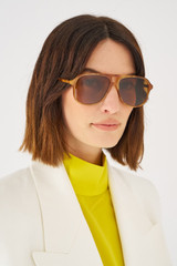 Profile view of model wearing the Oroton Folk Sunglasses in Maple Tort and Acetate for 