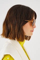 Profile view of model wearing the Oroton Folk Sunglasses in Maple Tort and Acetate for 