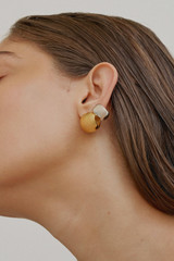 Profile view of model wearing the Oroton Josie Huggies in 18K Gold and Sustainably sourced 925 Sterling Silver for Women