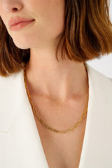 Profile view of model wearing the Oroton Gianna Paper Link Chain Necklace in 18K Gold and Sustainably sourced 925 Sterling Silver for Women
