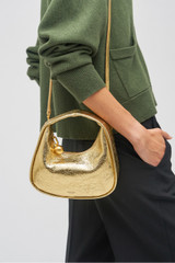 Profile view of model wearing the Oroton Clara Mini Bag in Gold and Metallic crinkle leather for Women