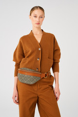 Profile view of model wearing the Oroton Harvey Signature Belt Bag in Black/Cognac and Nylon canvas base cloth material with PVC coating (70% PVC, 30% polyester) for Women .