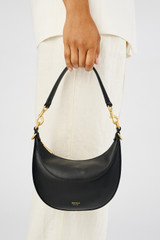 Profile view of model wearing the Oroton Florence Small Shoulder Bag in Black and Smooth leather for Women