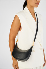 Profile view of model wearing the Oroton Florence Small Shoulder Bag in Black and Smooth leather for Women