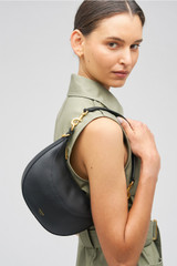 Profile view of model wearing the Oroton Florence Small Shoulder Bag in Black and Smooth leather for Women