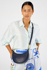 Profile view of model wearing the Oroton Florence Small Shoulder Bag in North Sea and Premium smooth leather for Women .
