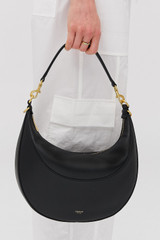 Profile view of model wearing the Oroton Florence Medium Hobo in Black and Smooth leather material for Women .