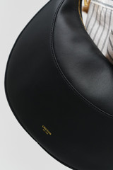 Profile view of model wearing the Oroton Florence Medium Hobo in Black and Smooth leather material for Women .