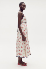 Profile view of model wearing the Oroton Dutch Tulip Halter Sundress in Ecru and 100% linen for Women
