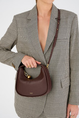 Profile view of model wearing the Oroton Clara Mini Bag in Bear Brown and Pebble leather for Women