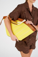 Profile view of model wearing the Oroton Callaway Tote in Amber/Daisy and Canvas for Women