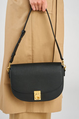 Profile view of model wearing the Oroton Yvonne Medium Day Bag in Black and Pebble Leather for Women .