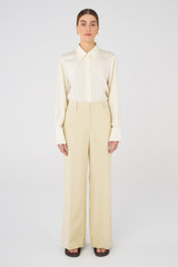Profile view of model wearing the Oroton Flat Front Pant in Almond and 58% Viscose, 42% Cotton for Women