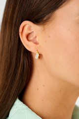 Profile view of model wearing the Oroton Calypso Hoop in 18K Gold and Sustainably sourced 925 Sterling Silver for Women