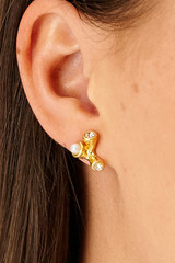 Profile view of model wearing the Oroton Lucia Studs in Worn Gold and Brass for Women