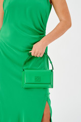 Profile view of model wearing the Oroton Della Small Baguette in Jewel Green and Smooth leather for Women