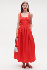 Profile view of model wearing the Oroton Tie Back Sundress in Poppy and 100% cotton for Women