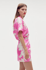 Profile view of model wearing the Oroton Silhouette Print Short Sarong Skirt in Carmine Pink and 100% silk for Women