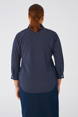 Profile view of model wearing the Oroton Stretch Silk 3/4 Sleeve Shirt in North Sea and 92% Silk, 8% Spandex for Women