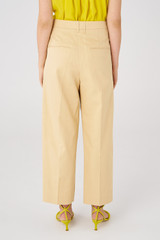 Profile view of model wearing the Oroton Twill Pleat Pant in Pink Sand and 77% cotton 23% linen for Women