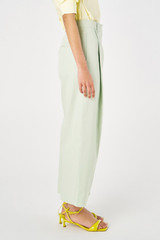 Profile view of model wearing the Oroton Twill Pleat Pant in Eau De Nil and 77% cotton 23% linen for Women