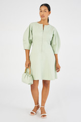 Profile view of model wearing the Oroton Short Utility Dress in Eau De Nil and 77% cotton, 23% linen for Women