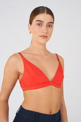 Profile view of model wearing the Oroton Silk Bralette in Poppy and 92% silk, 8% Spandex for Women
