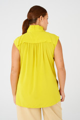 Profile view of model wearing the Oroton Sleeveless High Neck Top in Vivid Yellow and 92% silk, 8% spandex for Women