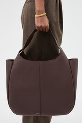 Profile view of model wearing the Oroton Emilia Large Tote in Bear Brown and Premium pebble leather for Women .