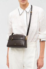 Profile view of model wearing the Oroton Audrey Texture Crossbody in Mahogany and Textured leather for Women