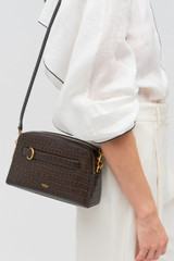 Profile view of model wearing the Oroton Audrey Texture Crossbody in Mahogany and Textured leather for Women