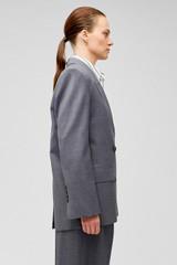 Profile view of model wearing the Oroton Man Style Blazer in Dark Ash and 50% wool, 50% recycled polyester for Women .