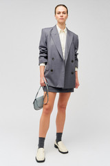 Profile view of model wearing the Oroton Man Style Blazer in Dark Ash and 50% wool, 50% recycled polyester for Women .
