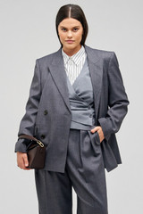 Profile view of model wearing the Oroton Man Style Blazer in Dark Ash and 50% wool, 50% recycled polyester for Women .