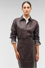 Profile view of model wearing the Oroton Embossed Croc Long Sleeve Overshirt in Burgundy and 100% leather for Women .