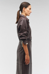 Profile view of model wearing the Oroton Embossed Croc Long Sleeve Overshirt in Burgundy and 100% leather for Women .