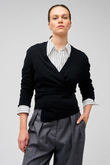 Profile view of model wearing the Oroton Wrap Cardigan in Black and 100% merino wool for Women