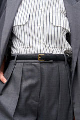 Profile view of model wearing the Oroton Florence 20MM Belt in Black and Smooth leather for Women .