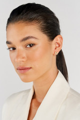 Profile view of model wearing the Oroton Leah Stud Earrings in Gold and Stainless Steel for Women .