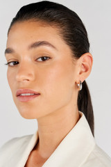 Profile view of model wearing the Oroton Raelyn Hoops in Silver and Brass for Women . IP:2