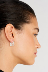 Profile view of model wearing the Oroton Leah Hoop Earrings in Silver and Stainless Steel for Women .