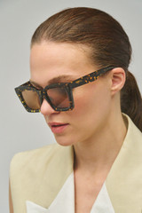 Profile view of model wearing the Oroton Reese Sunglasses in Neo Tort and Bio acetate for Women