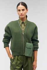 Profile view of model wearing the Oroton Margot Phone Crossbody in Moss and Pebble leather for Women .