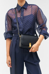 Profile view of model wearing the Oroton Etta Large Day Bag in Black and Premium smooth leather for Women .