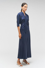Profile view of model wearing the Oroton Pindot Tie Neck Dress in North Sea and 100% SILK for Women .
