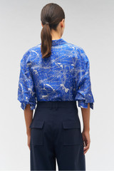 Profile view of model wearing the Oroton Long Sleeve Map Print Camp Shirt in Indigo and 100% silk for Women