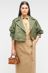 Profile view of model wearing the Oroton Crop Trench in Green Olive and 65% polyester, 35% cotton for Women