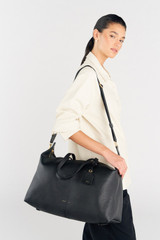 Profile view of model wearing the Oroton Heather Weekender Webbing Strap in Black/Brass and 100% Jacqard Webbing for Women .