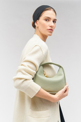 Profile view of model wearing the Oroton Clara Mini Bag in Cactus and Pebble leather for Women .